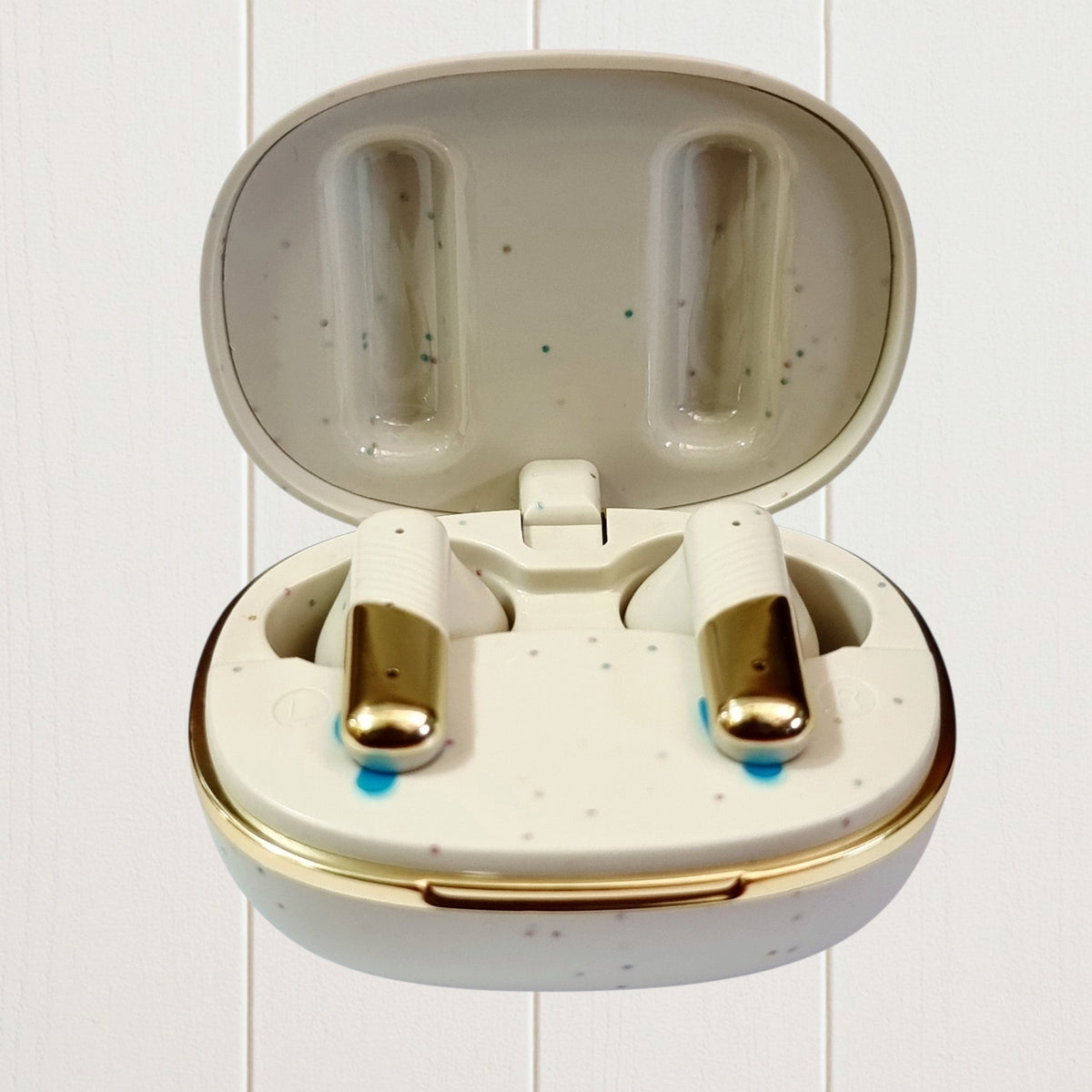 ADNAN MOBILE SHOP EarBuds 7 in a cream speckled charging case with gold accents and wireless earbud design
